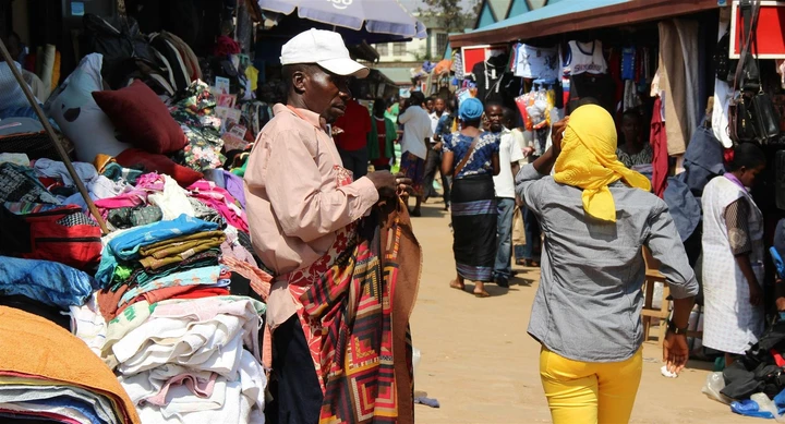 An array of vibrant clothes in a local market in Kigali, Rwanda
