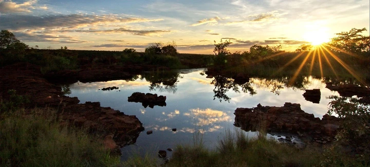 The sun sets over the water in the Waterberg