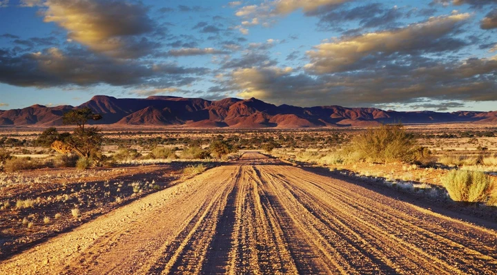 A dirt road stretching through the Namib desert